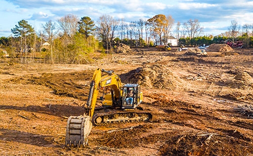 Excavator in a wide land of soil for cleaning